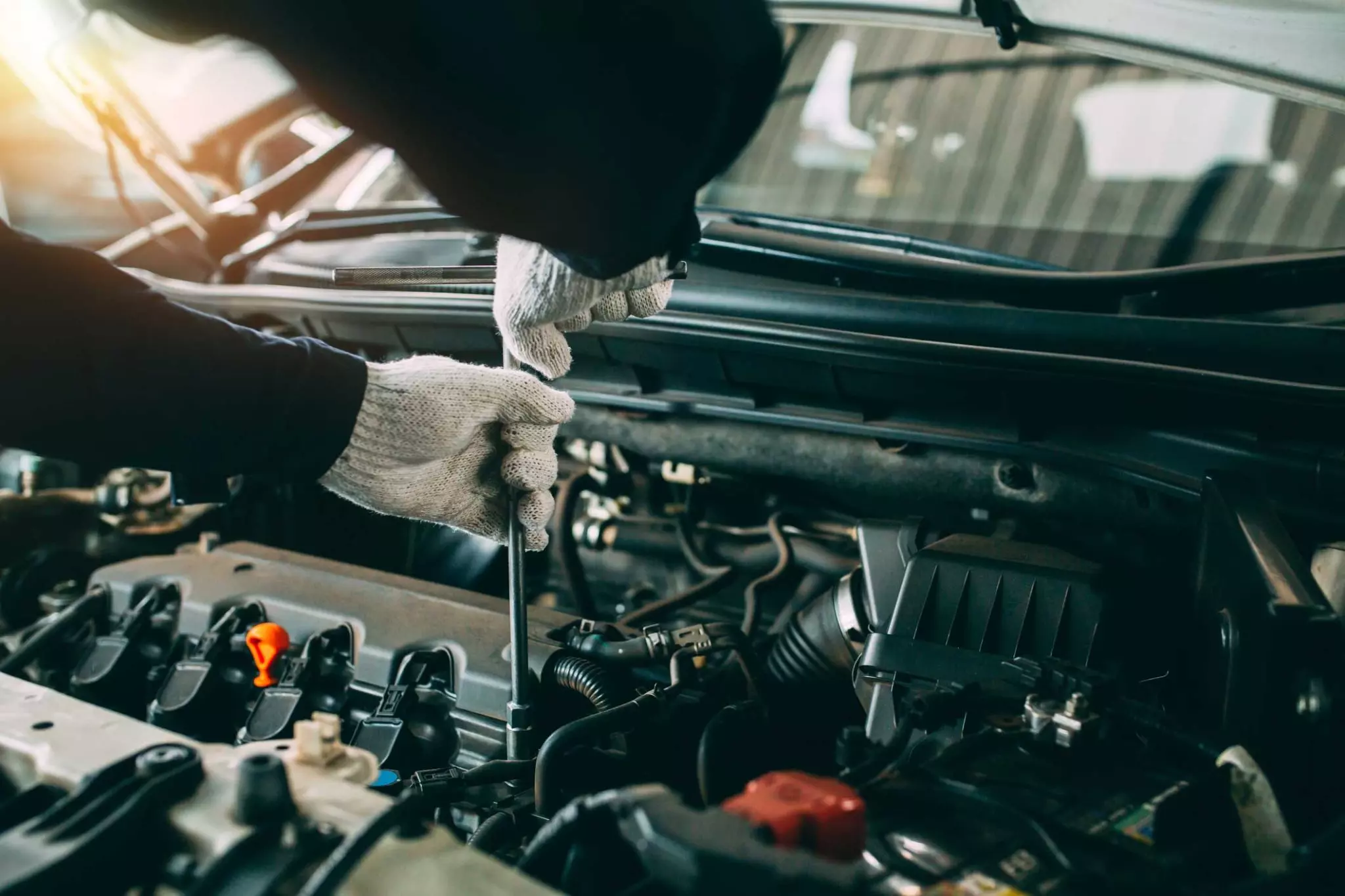 Technician working on a car engine
